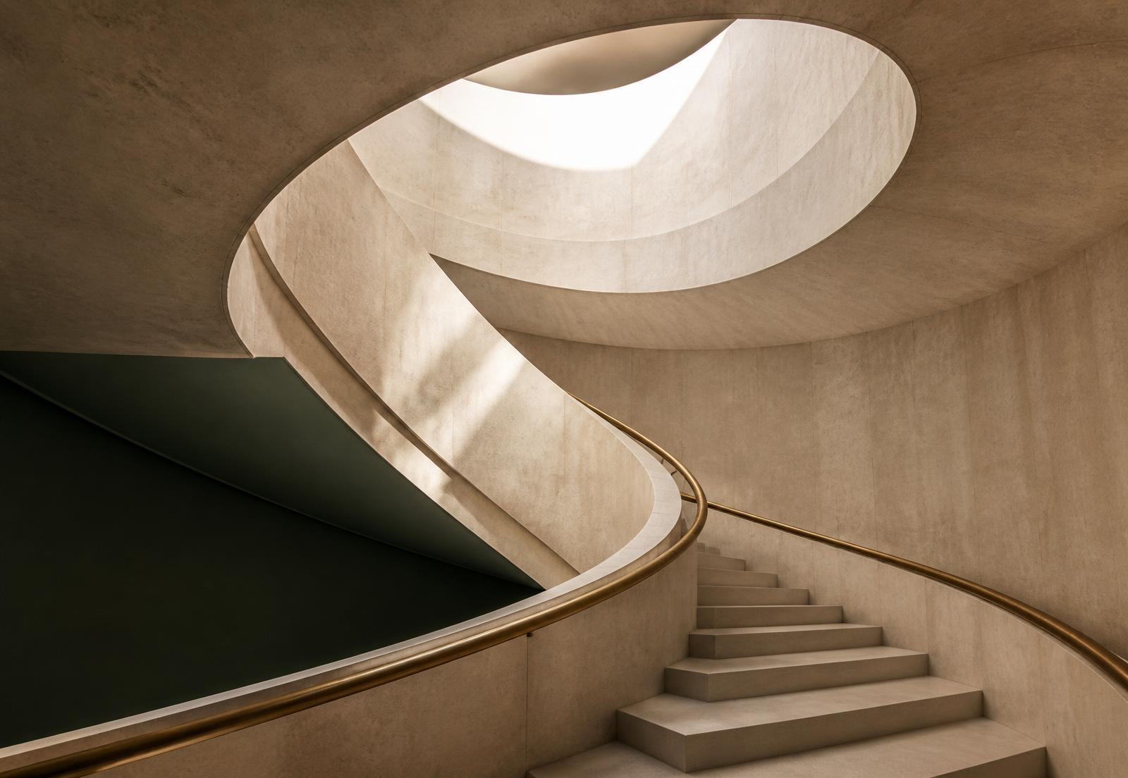 A staircase rising through a light-filled professional building